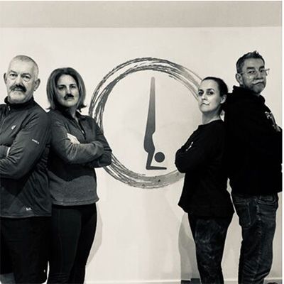 Standing Movember supporters with arms crossed, looking to camera.